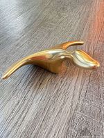 Front three-quarter view of gold-plated Hoselton abstract animal sculpture