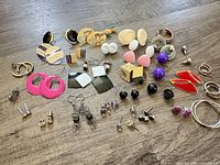 Wide overview of all earrings laid out on surface