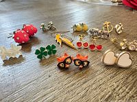 Overview of all novelty earrings spread on table