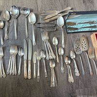 Flat lay of entire mixed flatware and serving pieces with presentation case