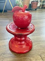 Pedestal stand with apple on top