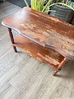 oblique view showing full table, upper and lower shelves, turned legs