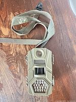 Front view of Tasco trail camera with strap attached