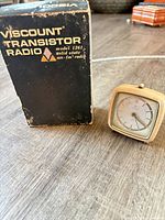 Viscount transistor radio box beside Junghans travel alarm clock
