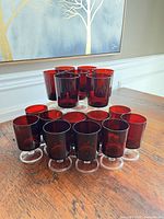 Front view showing all 16 ruby red goblets arranged by size
