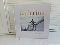 Front cover showing title, photo inset, light pink cloth and gold lettering