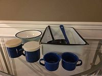 all enamelware items grouped on table