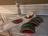 Tray, candle holder, six napkin rings displayed