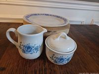 Set showing creamer, lidded sugar bowl, dinner plate