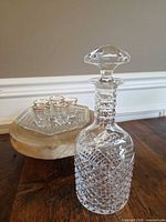 Decanter with stopper, three shot glasses on square tray
