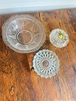 Group shot of etched serving bowl, lidded candy dish with fruit knob, starburst plate