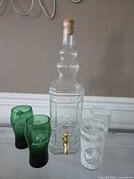 Full lot: dispenser with cork, two clear etched glasses, two green tumblers