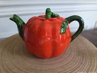 Front view of pumpkin-shaped teapot