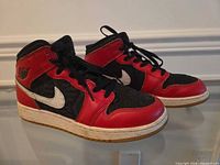 full view of pair of Jordan sneakers side profile