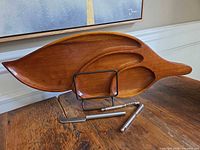 Front view of wooden leaf platter on stand with knife and nutcracker