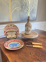 Lot overview showing plates, bottle, riser, tools