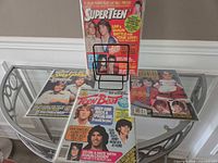 All four bagged magazines on glass table