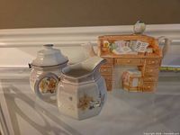Creamer, sugar bowl and desk-shaped teapot grouped together