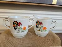 Creamer and sugar bowl side by side showing rooster decals and form