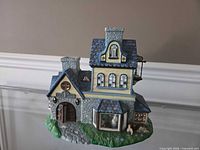 Front view showing overall structure, front door, chimneys, roof detail