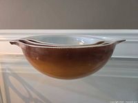 Side view of largest bowl showing brown exterior and white rim
