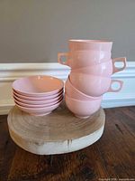Stack of 6 cups and 5 saucers on wood base