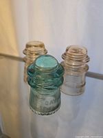 Front view of all three insulators showing colors and embossing