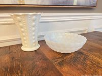 Vase and bowl side by side on table