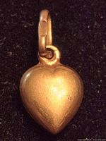 Front view of yellow gold heart pendant with bail
