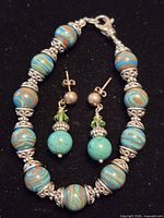 Bracelet and earrings grouped on black background