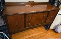 Front view showing full sideboard, doors, drawers, backsplash, legs