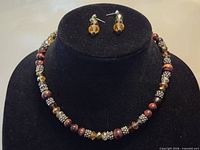 Necklace and earrings full view on display bust