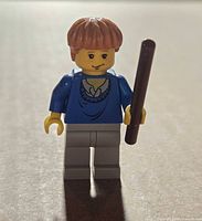 Front view of Ron Weasley minifigure holding wand