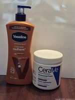 Front view of both unopened items: CeraVe cream jar and body lotion pump bottle