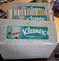 Front view of three sealed Kleenex hand towel boxes