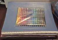Unopened gel pen pack on top of file folders