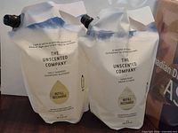 Both Unscented Company 2 L refill pouches standing upright