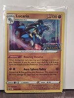 Front of Lucario holo promo card showing artwork, foil, set stamp, number SWSH186