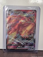 Front of Blaziken VMAX card in sleeve and top loader
