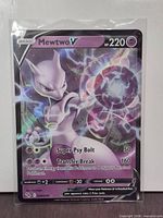 Front of sleeved Mewtwo V Pokémon GO card