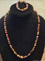Necklace and bracelet displayed on bust