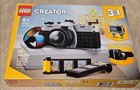 Front of sealed LEGO Creator 31147 box showing primary retro camera build and 261 piece count.