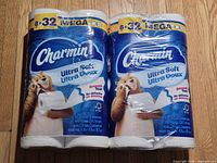 Front view of both sealed Charmin Ultra Soft packs on floor