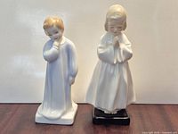 Both Royal Doulton porcelain child figurines standing side by side