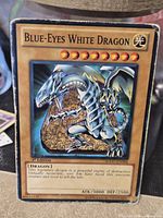 Front of Blue-Eyes White Dragon card showing artwork, attribute, 1st Edition text and card stats