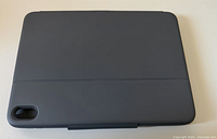 Back view of the dark gray Logitech Rugged Folio closed, showing rear camera cutout and overall condition