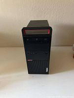 Front view of Lenovo ThinkStation P310 tower showing optical drive, power button and branding