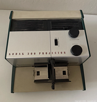 Front view showing Kodak 300 Projector branding, twin slide carrier, focus and elevation knobs