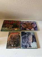 Front covers of four wildlife books arranged on a table