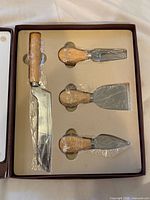 Box interior showing four sealed cheese knives